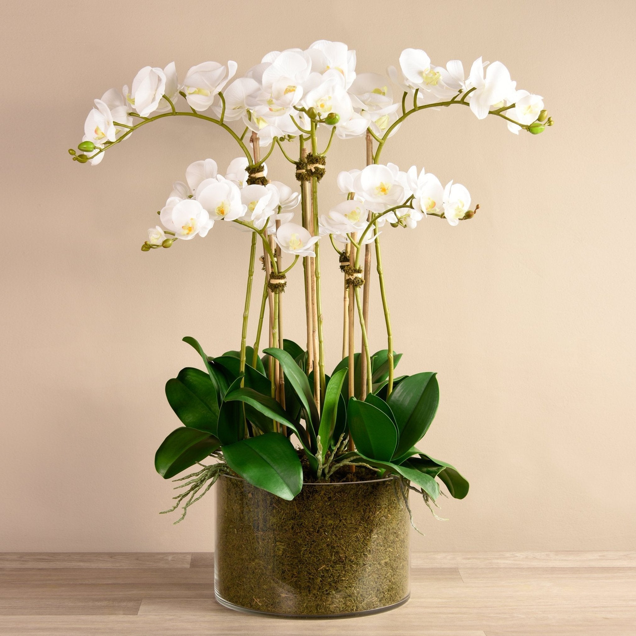 Large faux white orchid arrangement in glass vase-0