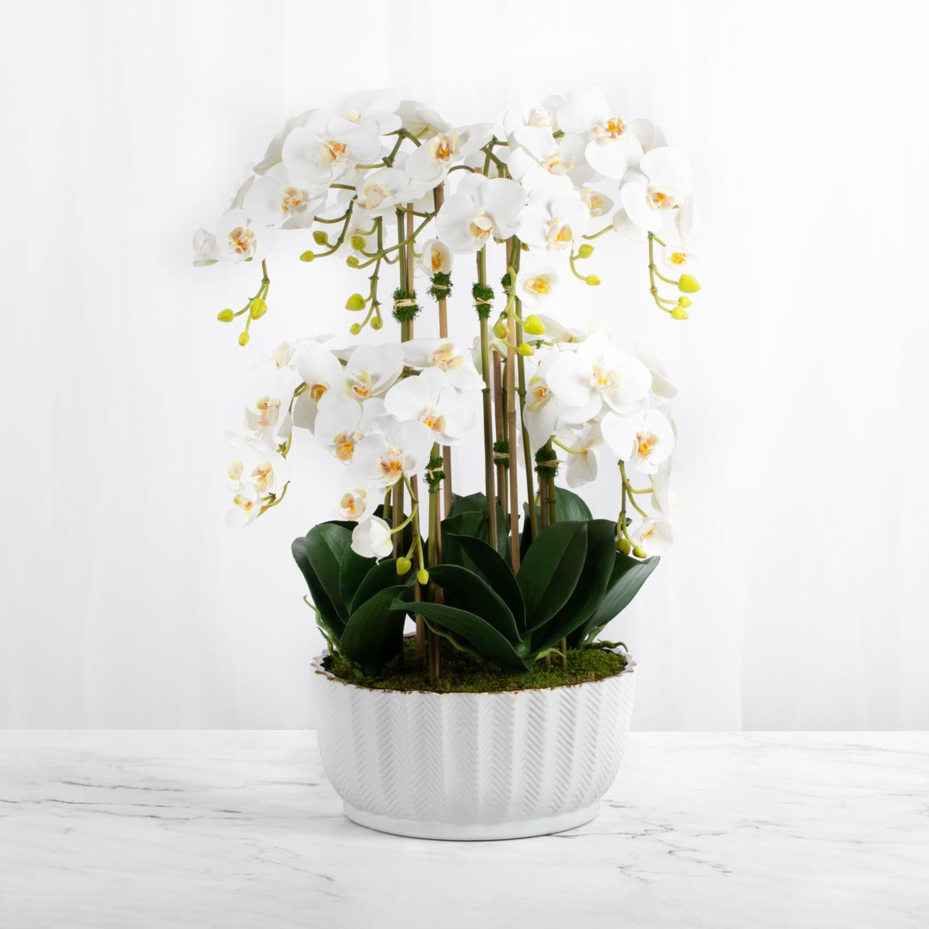 Faux orchid centerpiece in white vase