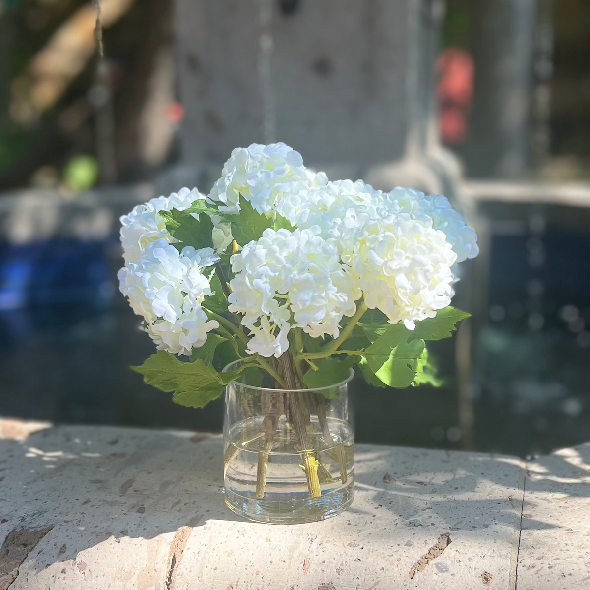 Real touch white hydrangea arrangement in glass vase - 8"