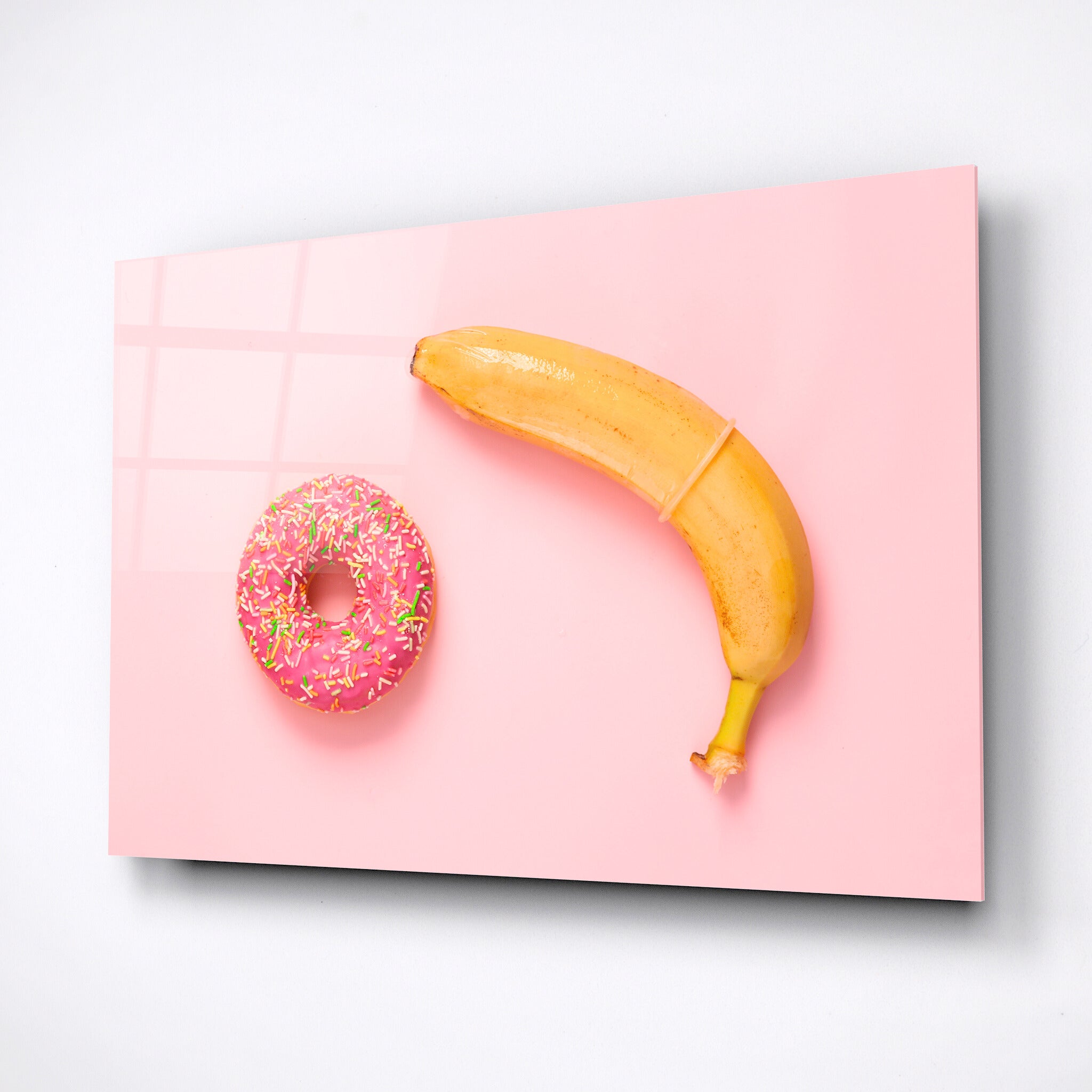 Wall decor, yellow banana with condom and donut