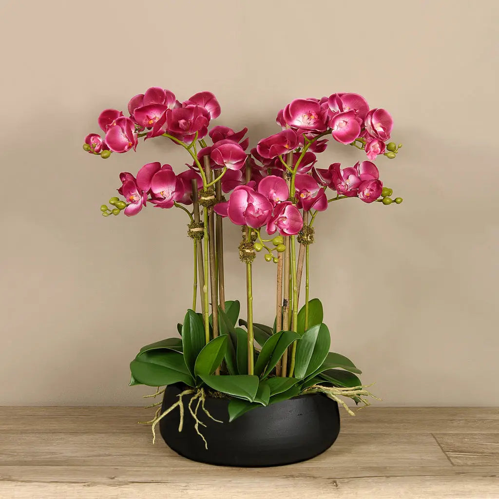 Artificial floral arrangement centerpiece with pink orchids in black planter-1